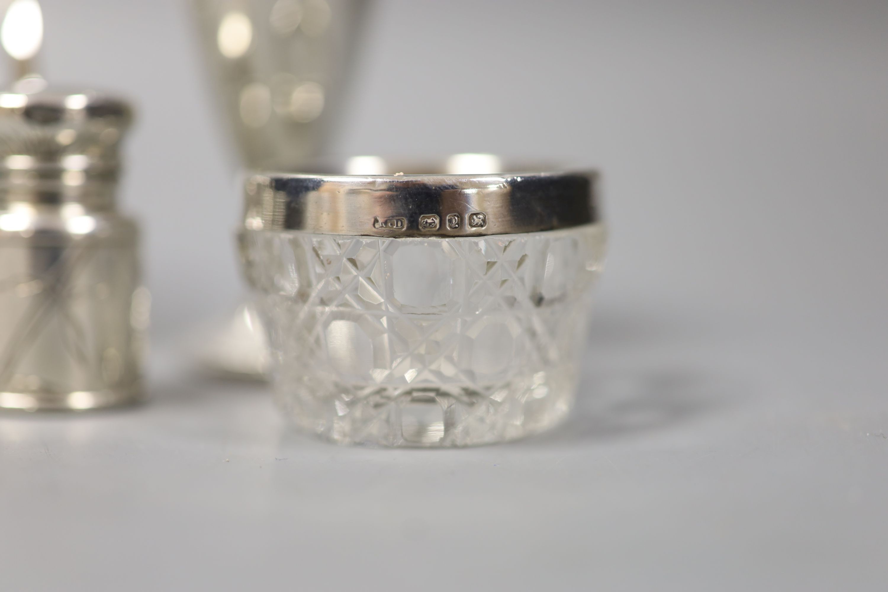 A silver toastrack, four silver mounted glass jars, a small silver goblet, and a Victorian silver scent bottle, London, 1883, 44mm.